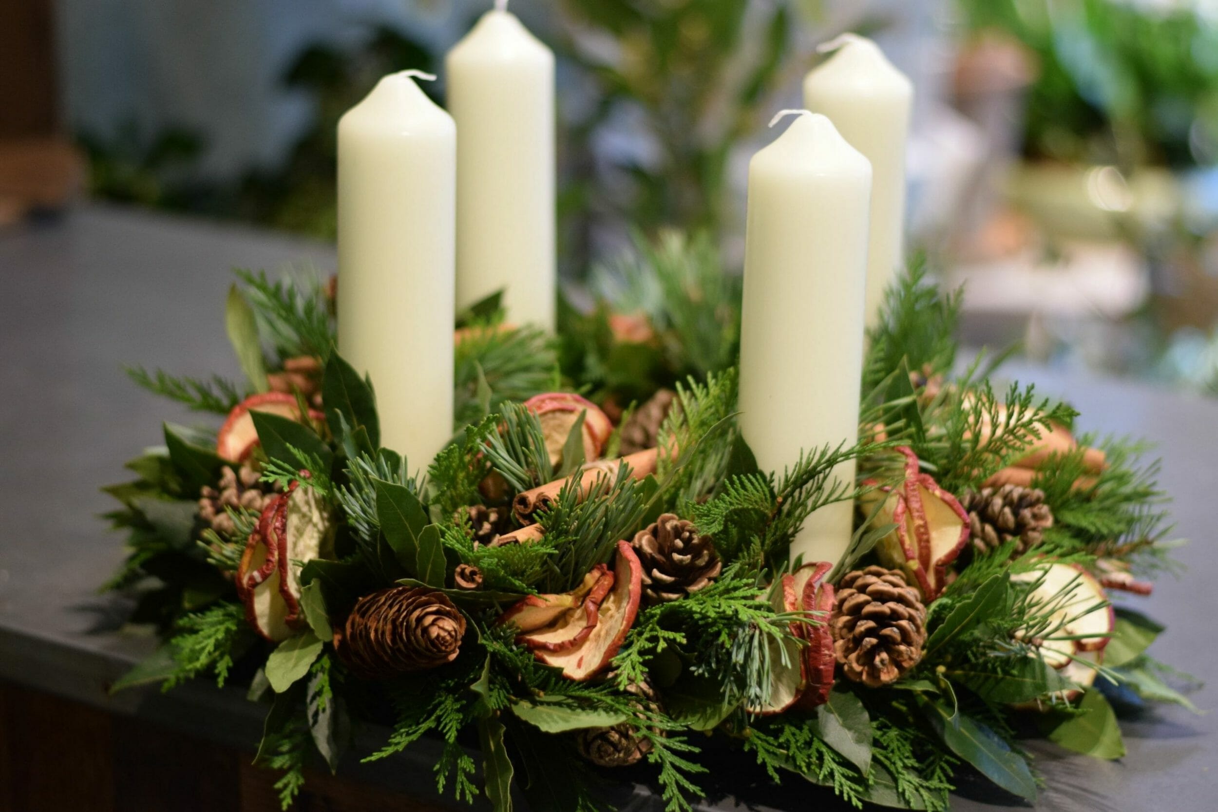 Photo showing a Christmas Advent Candle-arrangement mixed pines, fruits and cones Kensington flowers London