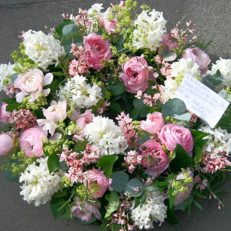 Photo showing a Wreath funeral flowers tribute Pink spring flowers Kensington flowers