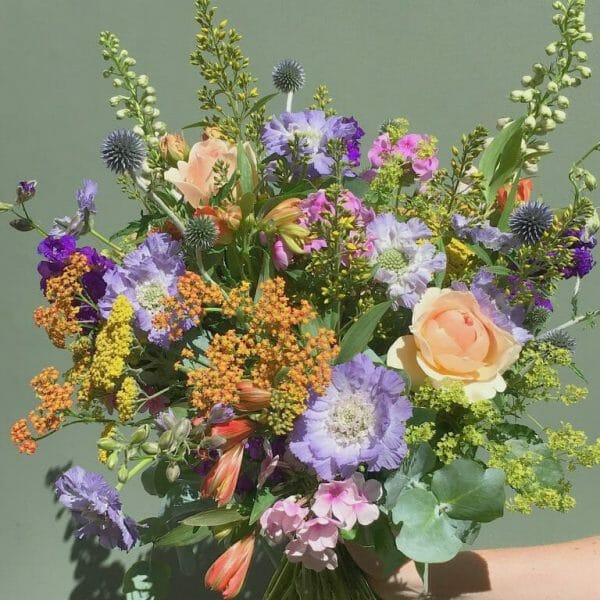 Photo showing a mix pastel Handful bunch of British flowers available from Kensington flowers London