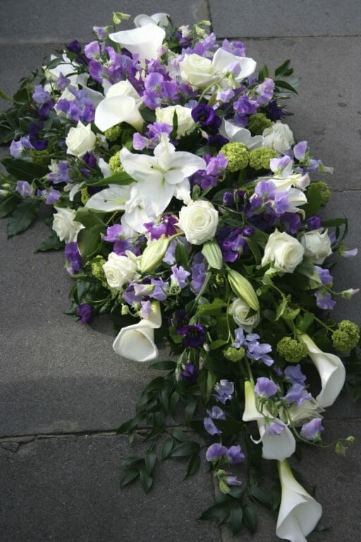 Photo of a Funeral floral tribute White and purple flowers spray arrangement Kensington Flowers