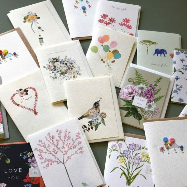 Photo showing a sample selection of handmade gift cards available to but with flowers