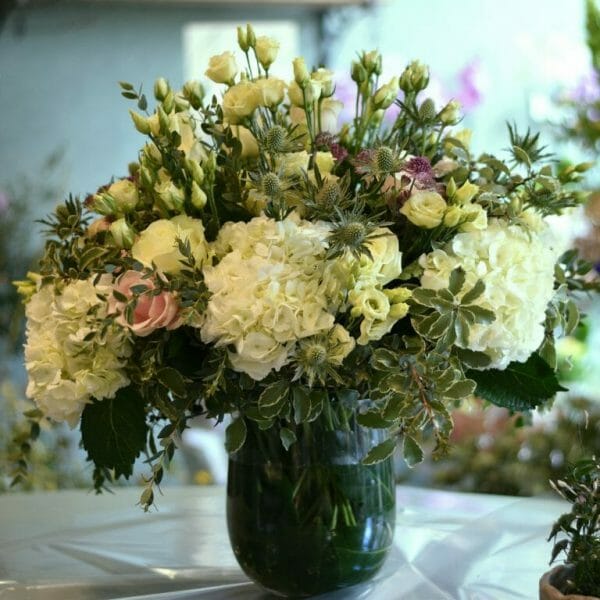 Photo showing a sample of a Seasonal classic vase arrangement, available to order from Kensington Flowers London