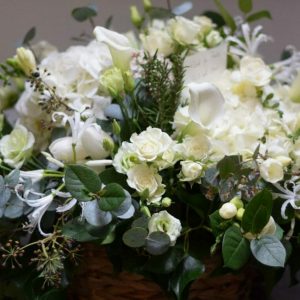 Photo of a posy arrangement of all white flowers funeral flowers from Kensington flowers.