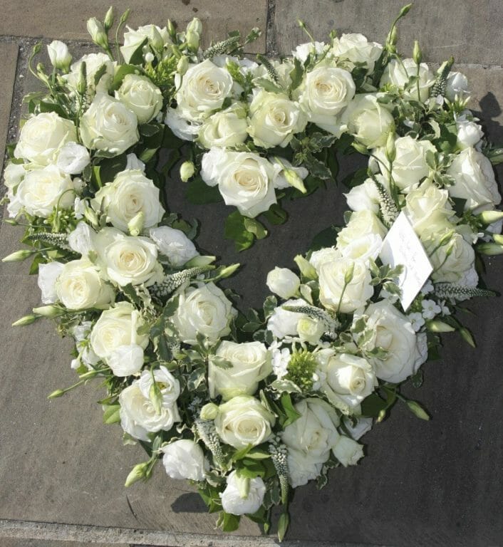 Photo of a all White open heart funeral tribute from Kensington Flowers