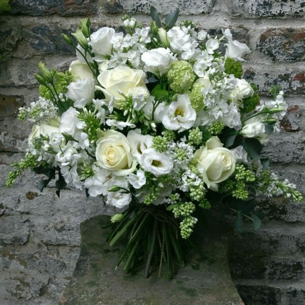 Photo showing a sample of a white Seasonal Hand Tied Bouquet available to order from Kensington Flowers London