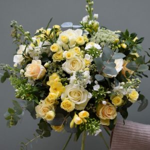 Photo showing a sample of a seasonal rose bouquet in yellow and white Kensington flowers