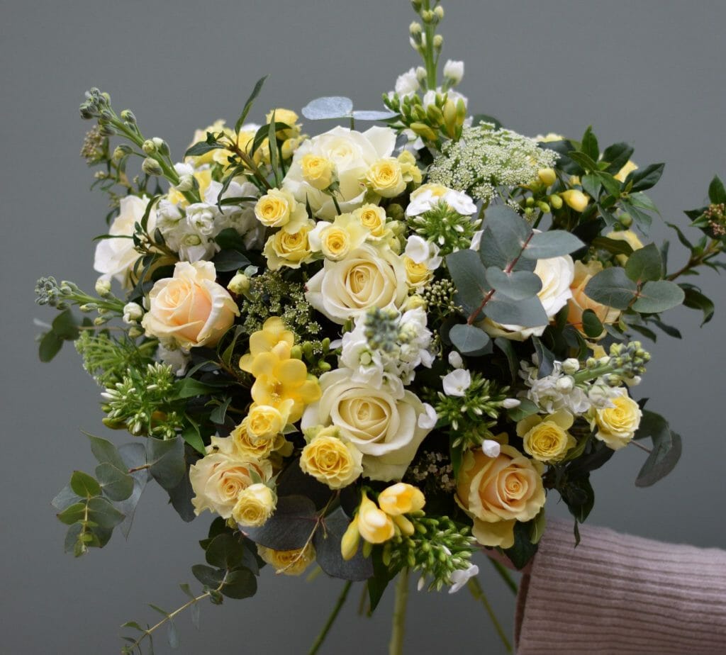 Photo showing a sample of a seasonal rose bouquet in yellow and white Kensington flowers