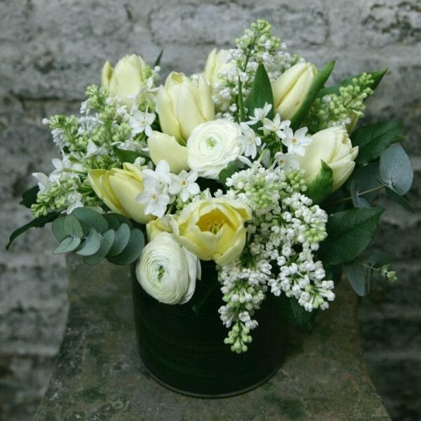 Photo showing a sample of a Seasonal Classic Vase Arrangement - spring lemon and white colours - Kensington flowers, London