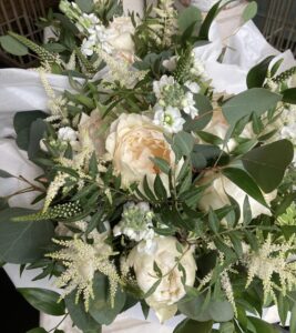 Bridal bouquet containing scented garden roses, veronica, astilbe and eucalyptus foliage.
