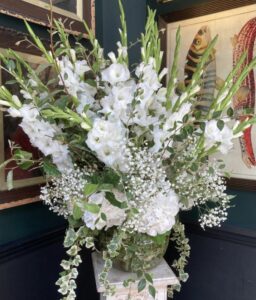 Urn filled with gladioli, hydrangea and gyposophila