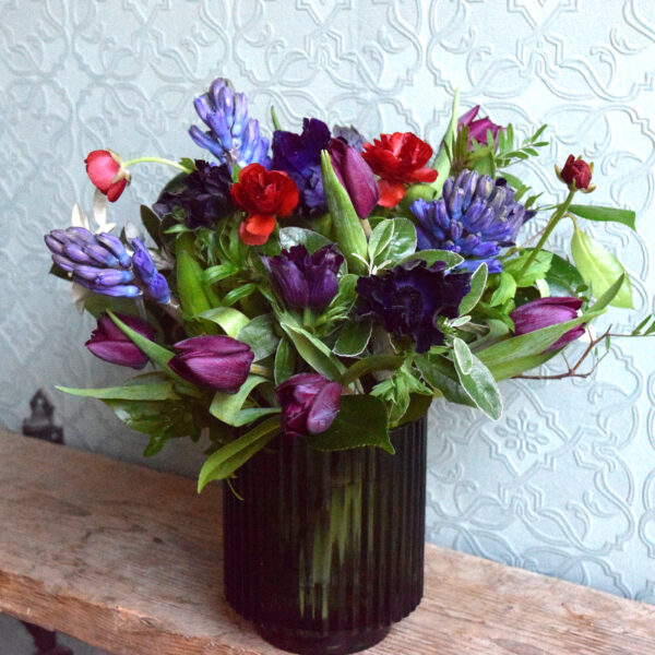 Photo showing a sample of a Spring flower vase arrangement in mixed colours available to order from Kensington flowers London