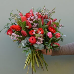 Photo showing a sample of one of the Spring flower bouquet in red and pink, available from Kensington Flowers London