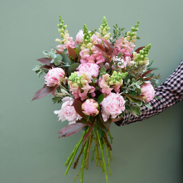 Photo showing a sample of a seasonal peony bouquet in pink shades available to order from Kensington flowers London