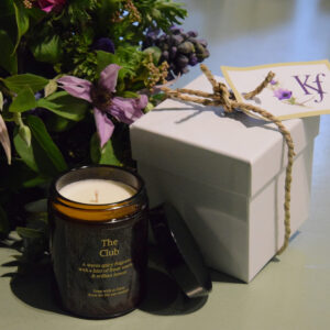 Photo showing a sample of the flowers and scented candle gift set available from Kensington Flowers London